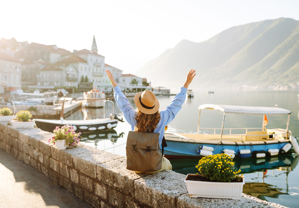 acliviaggi-tourist-woman-admiring-view-colorful-view-city-back-view-europe-travel-lifestyle-nature